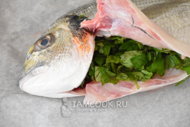 Положить в брюшко рыбы базилик