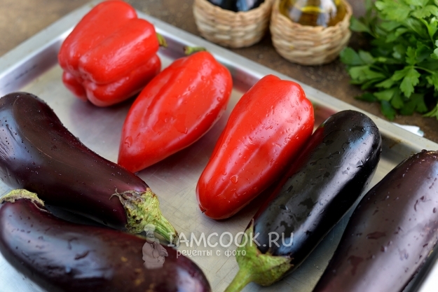 Положить на противень баклажаны и перцы