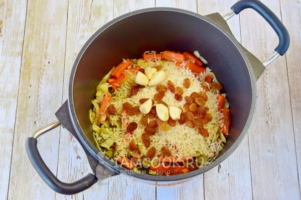 Положить изюм и чеснок