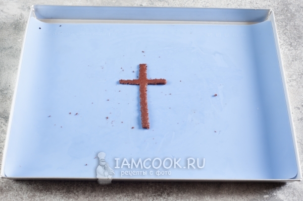 Положить крест из теста на противень