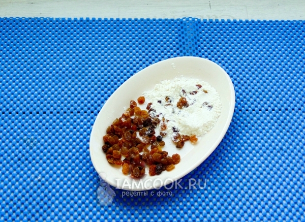 Обвалять изюм в муке