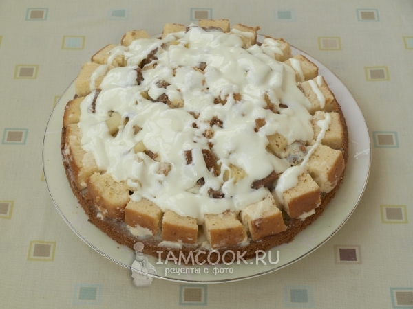 Выложить кусочки бисквита, крем и ананасы