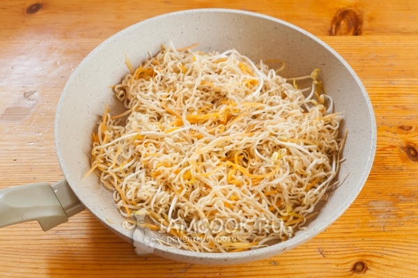 Положить на сковороду лапшу и морковь