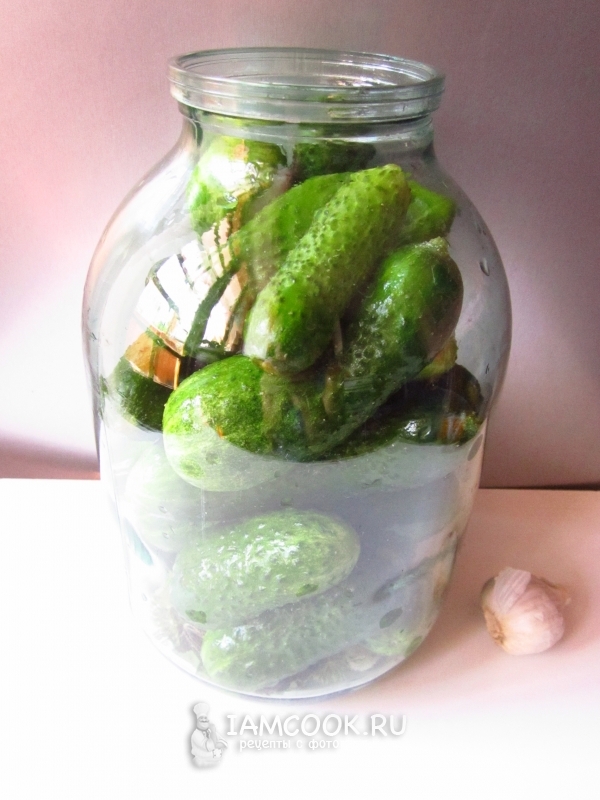 Уложить в банку огурцы